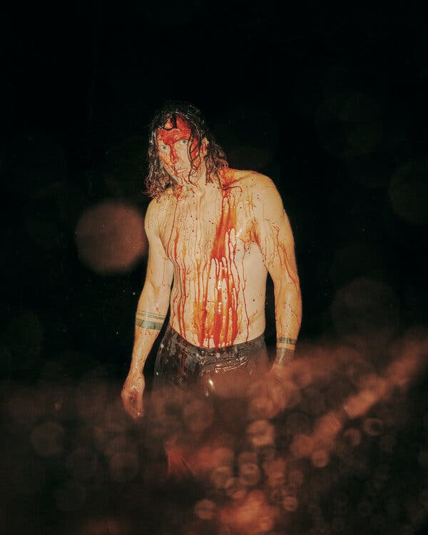 John Adams, a former model, is covered in fake blood.
